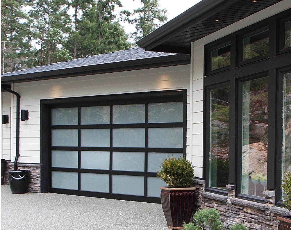 Exterior, modern contemporary home, James Hardie Cobblestone siding, Black windows, dark gray roof, black and glass garage door, black gutters, soffits, and downspouts