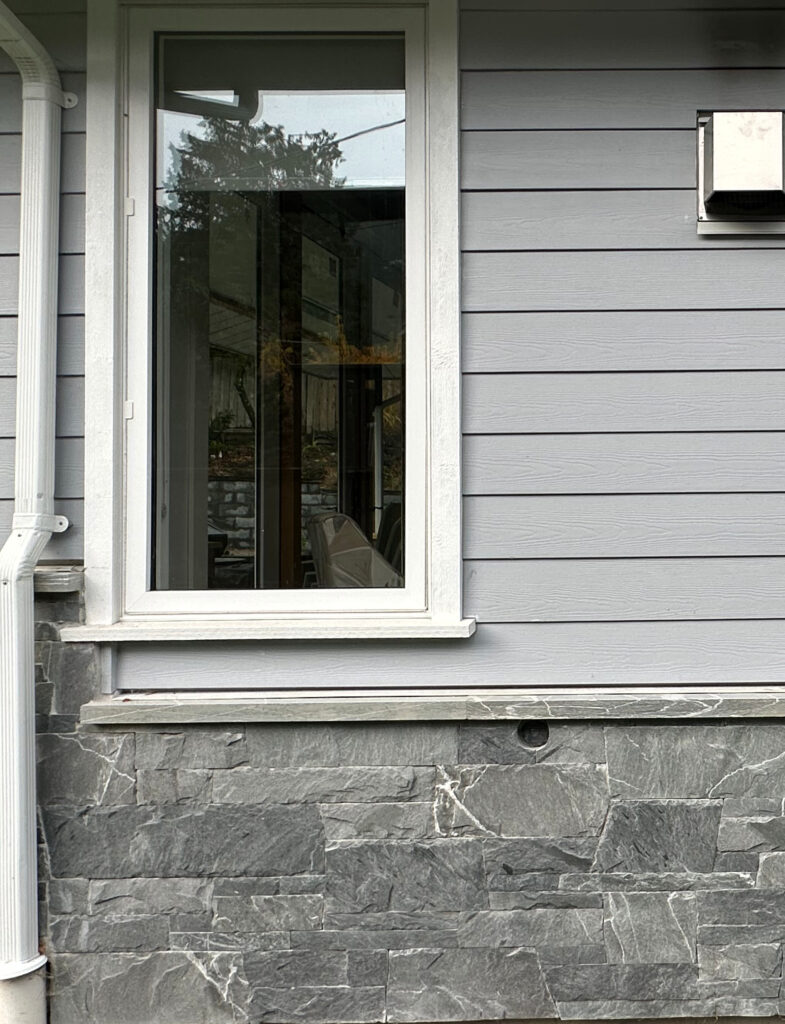 White trim with white windows, K2 exterior stone with Benjamin Moore Silent Night on exterior siding
