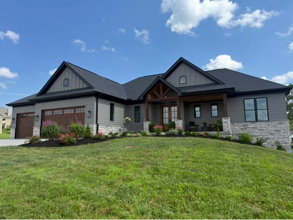 Sherwin Williams Gauntlet Gray exterior siding with black trim, stone facade, single storey rancher