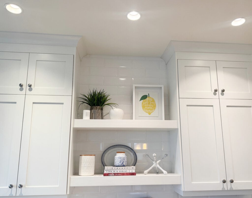 Sherwin Williams Pure White painted kitchen cabinets and ceiling, white floating shelves, subway tile, home decor