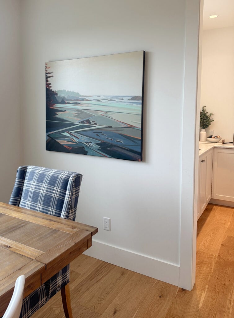 Sherwin Williams Pure White walls and trims with lights on in pantry and off in dining room. White oak floor, Fiona Dalrymple artwork