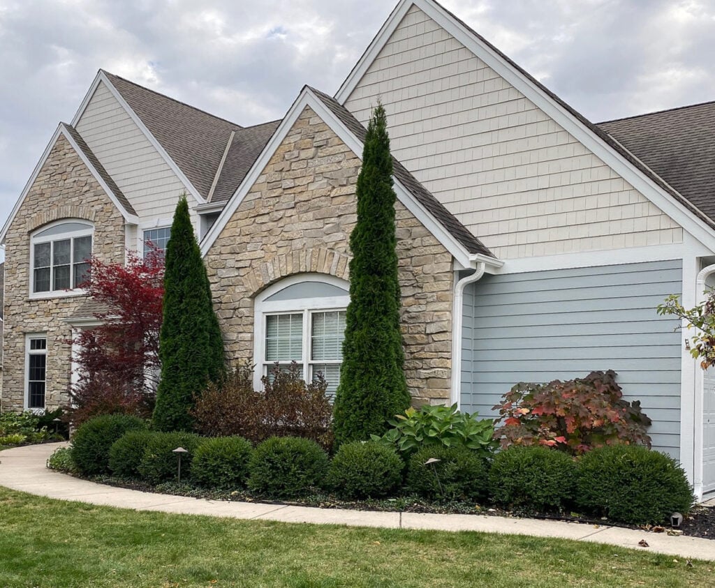 exterior painted, Sherwin Williams Aesthetic white darkened, Mineral Deposit, gray, asphalt roof, stone. White windows