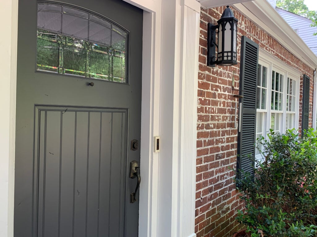 red brick exterior with Sherwin Williams Pure White trim and Benjamin Moore Cheating heart, best blue-black front door paint color