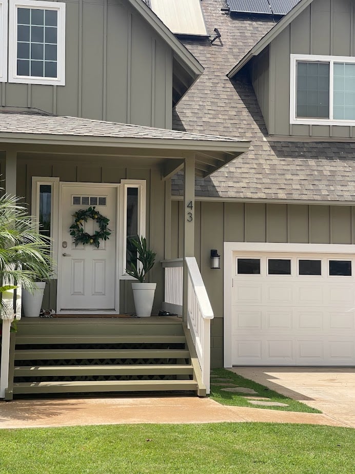 Green exterior with off-white front door, trim and garage door, hawaii