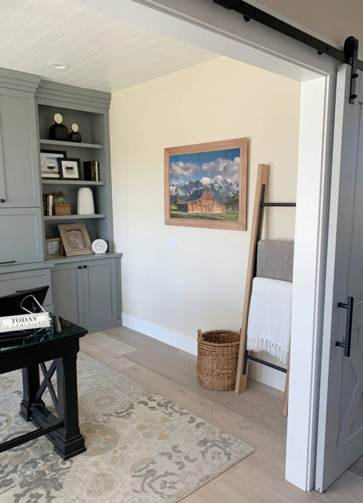 Home office with built-in cabinets painted Magnolia Teak Kettles with off-white paint color on waqlls and whitewashed wood flooring
