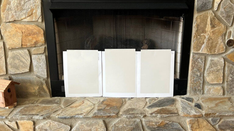 SAmples of Sherwin Williams Shoji White, Aesthetic White, and Egret White with 1970s or 80s stone fireplace
