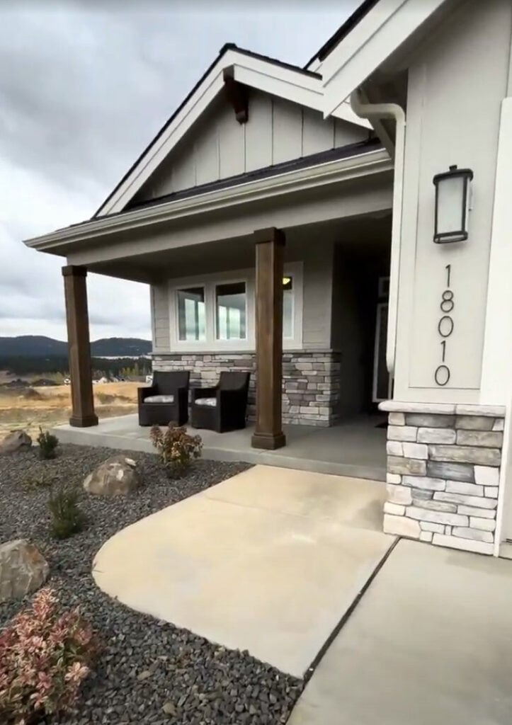 Sherwin Williams Agreeable GRay exterior siding with white trim and stone facade - Copy