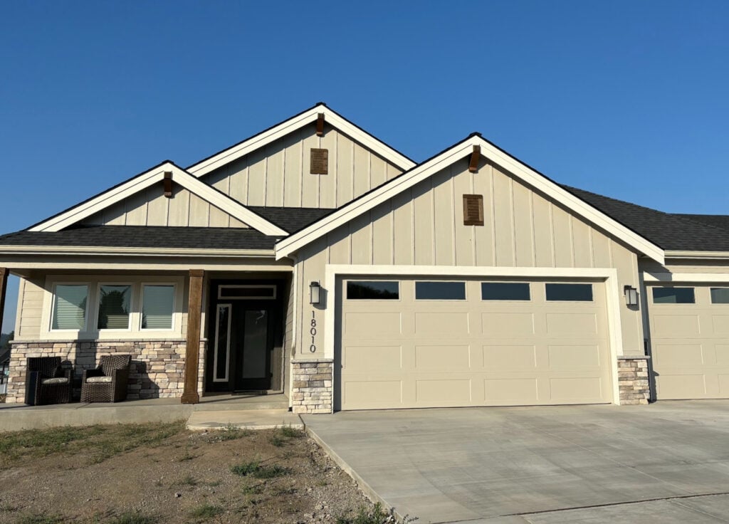 Sherwin Williams Agreeable Gray in west-facing afternoon sunhine on exterior with Pure White trim and wood beams