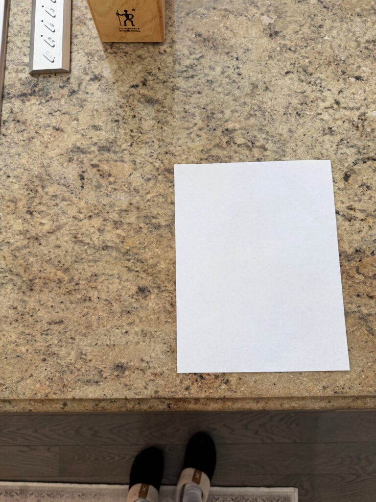 Beige granite countertop with gray flecks from early 2000s