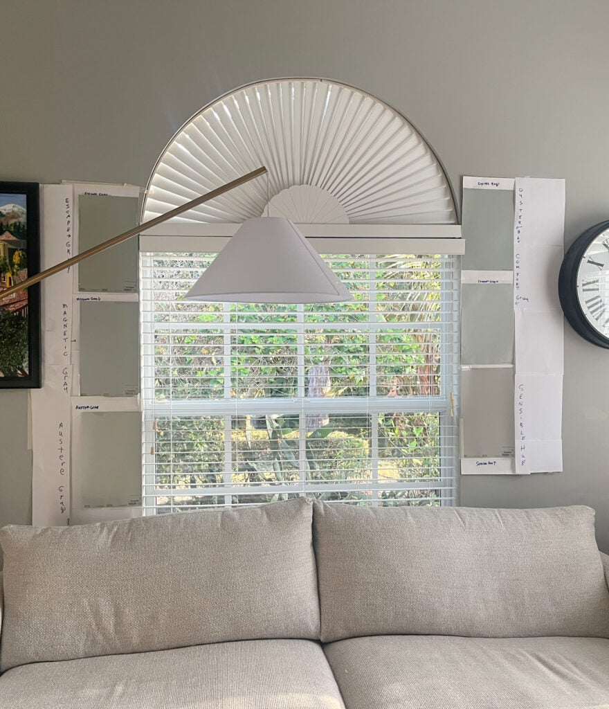 Sherwin Williams Escape Gray, Magnetic Gray, Austere Gray compared to samples of other green gray blues like Oyster Bay, Comfort Gray and Sensible Hue against a taupe sofa