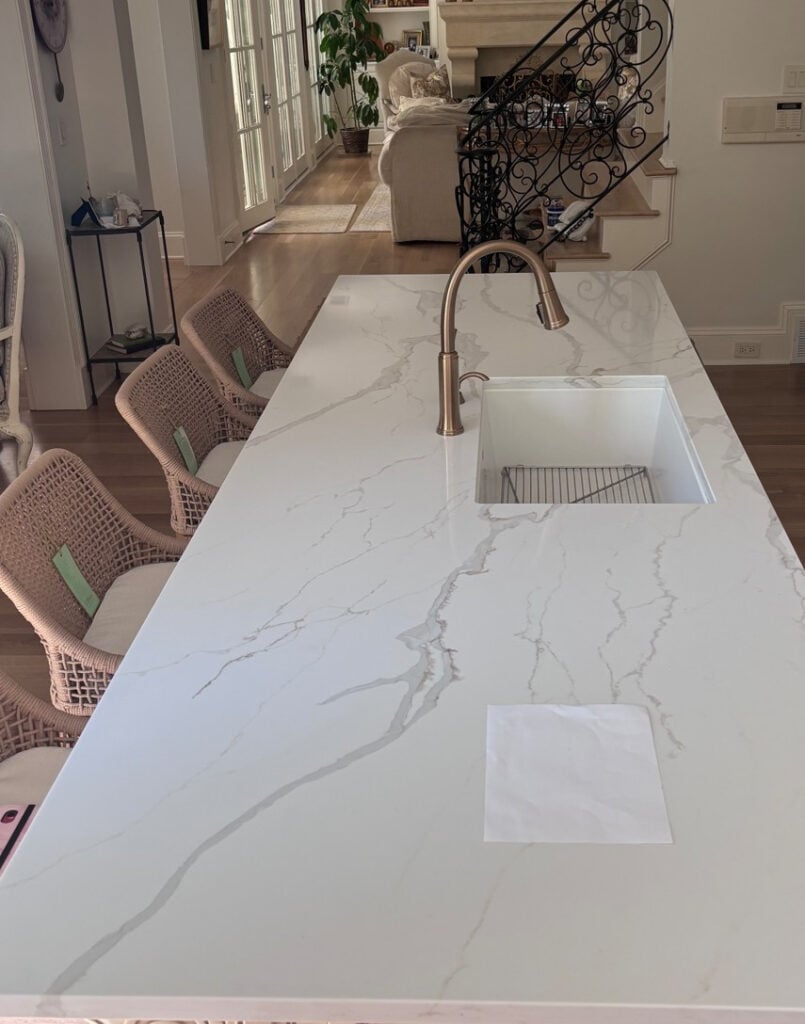 Crescent Quartz Calacatta Caramelo white quartz with gray veins and beige, brown