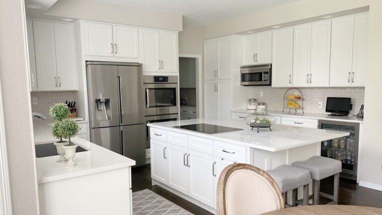 Benjamin Moore White Dove kitchen cabinets with taupe subway tile backsplash, Ironsbridge quartz countertops on island
