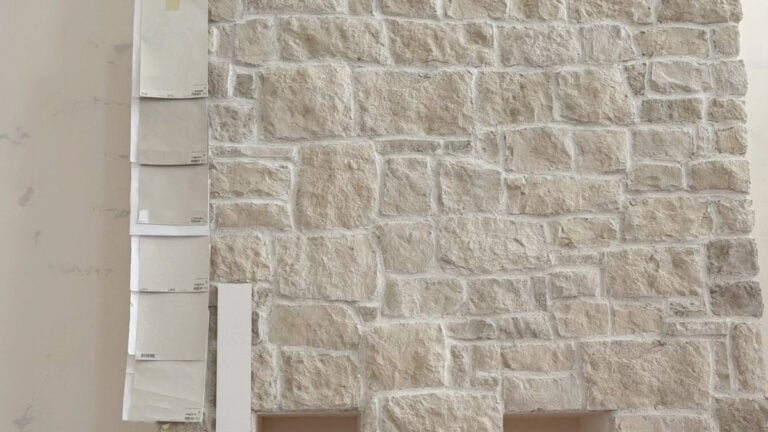 Limestone beige fireplace with paint color samples that coordinate