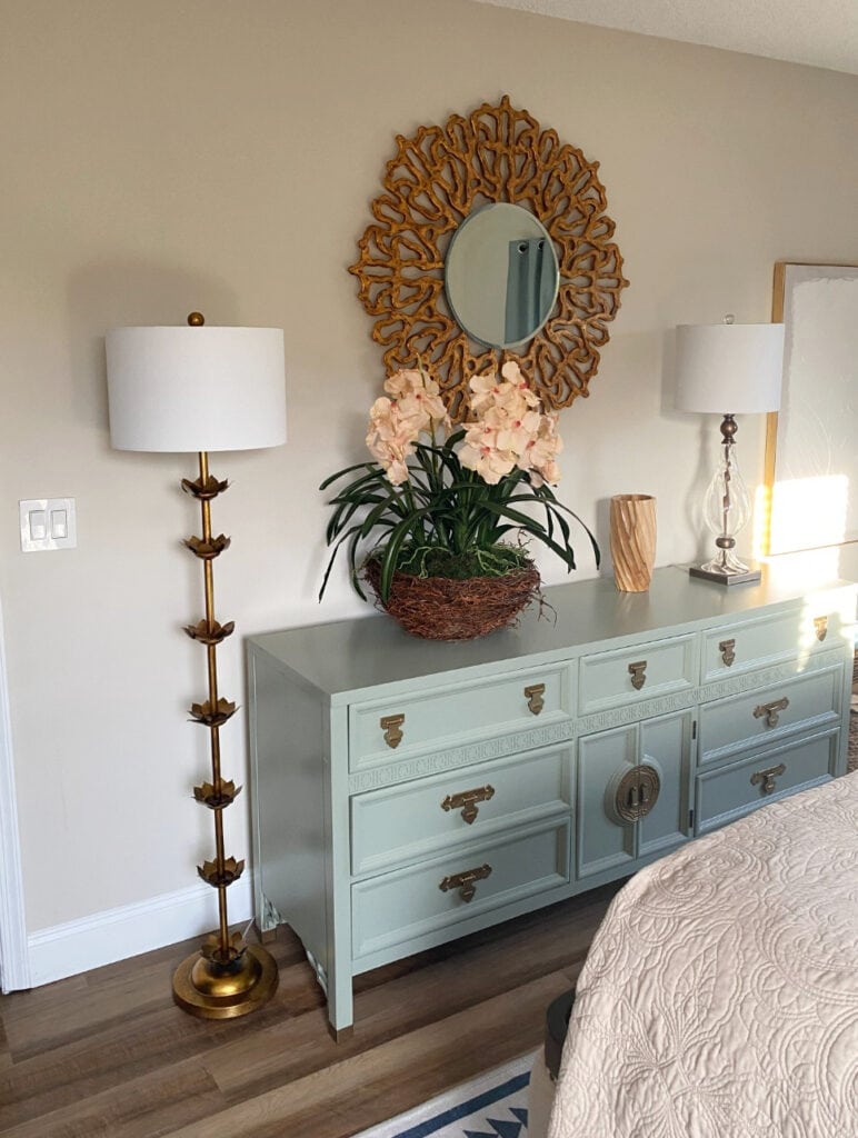 BEnjamin moore Edgecomb Gray on walls with green-blue painted dresser, wood floor, tropical style home decor in guest bedroom