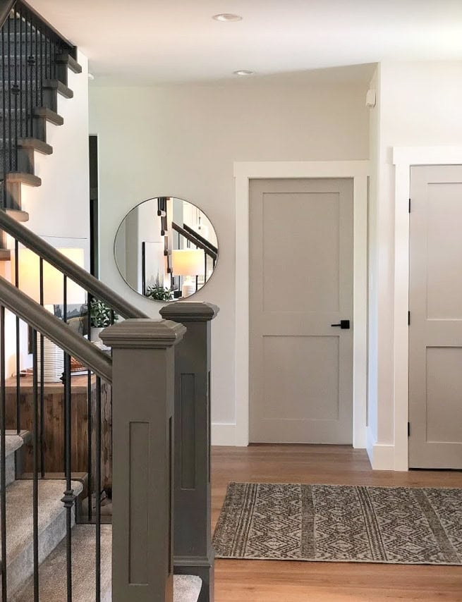 Benjamin Moore REvere Pewter (darkened) painted interior doors with White Dove trim, lightened Edgecomb Gray on walls. Urbane Bronze on painted staircase railings and pots. Dark entryway