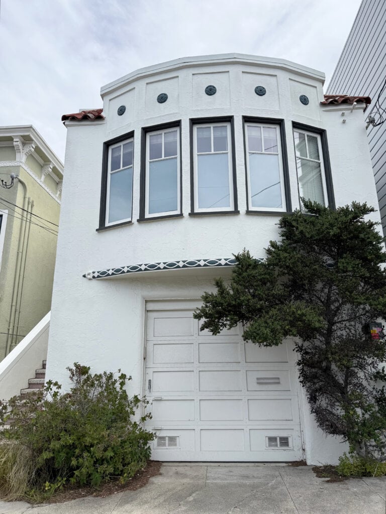 Benjamin Moore Swiss Coffee and African Night on unique home, painted windows and garage door