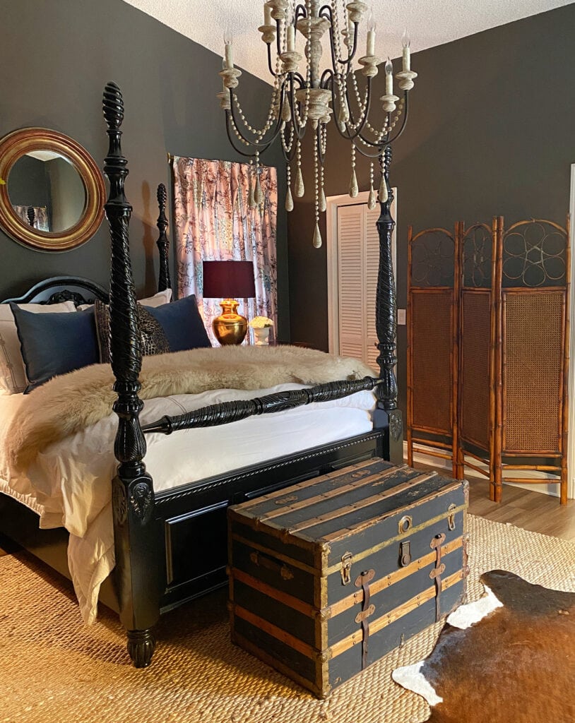 Moody primary bedroom with Sherwin Williams Urbane Bronze walls, vaulted ceiling, area rug and cowhide with black 4 poster bed (1)