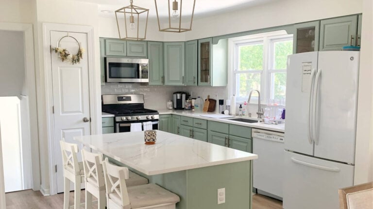 Sage green painted kitchen cabinets, Cascade Green 1990s update with white quartz and appliances