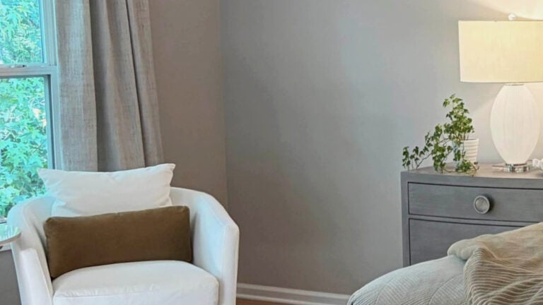 Sherwin Williams POpular Gray in bedroom with north-facing natural light, off-white accent chair and drapes