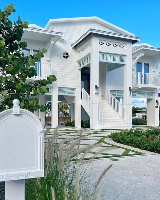 Sherwin Williams Pure White exterior of coastal style home with Tradewind blue accents.