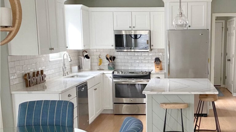 Kitchen with Sherwin Williams Pure White painted cabinets, Austere Gray (Green), white subway tiule backsplash and quartz.