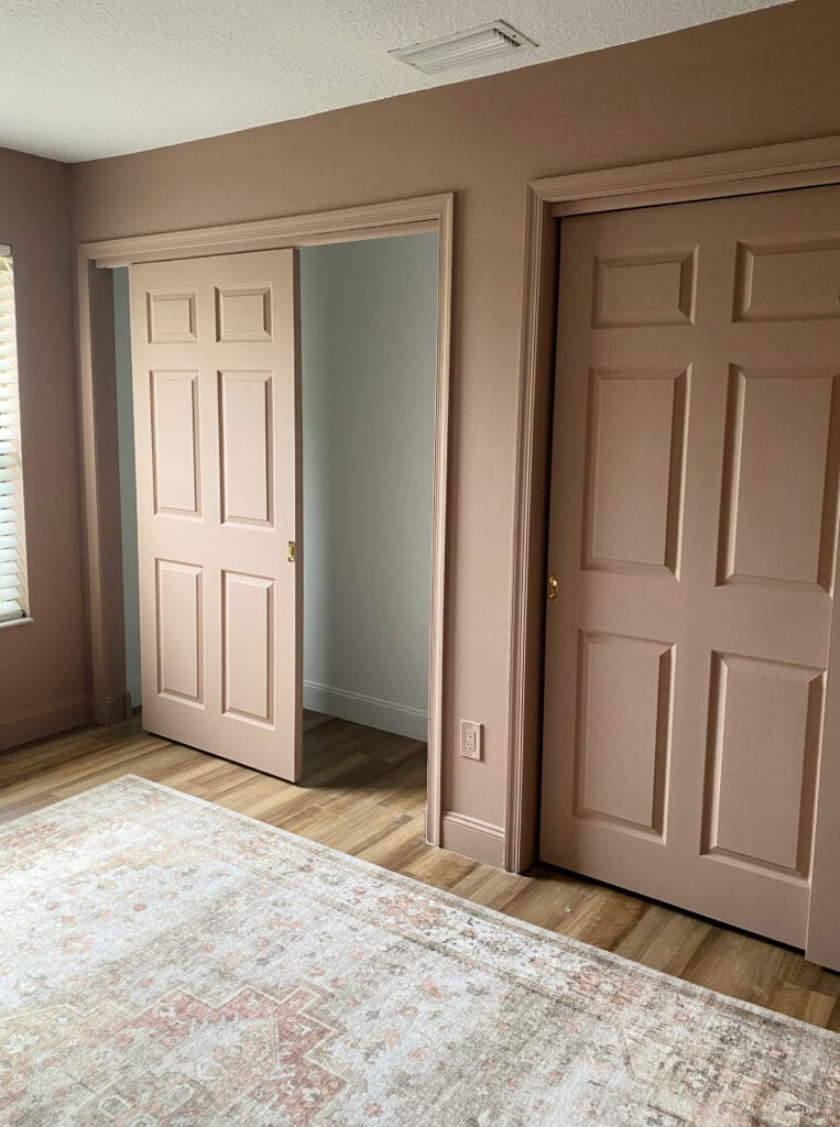 Sherwin Williams Redend Point, northeast-facing light. Brownish pink paint color with wood floor. Color drench except for the ceiling