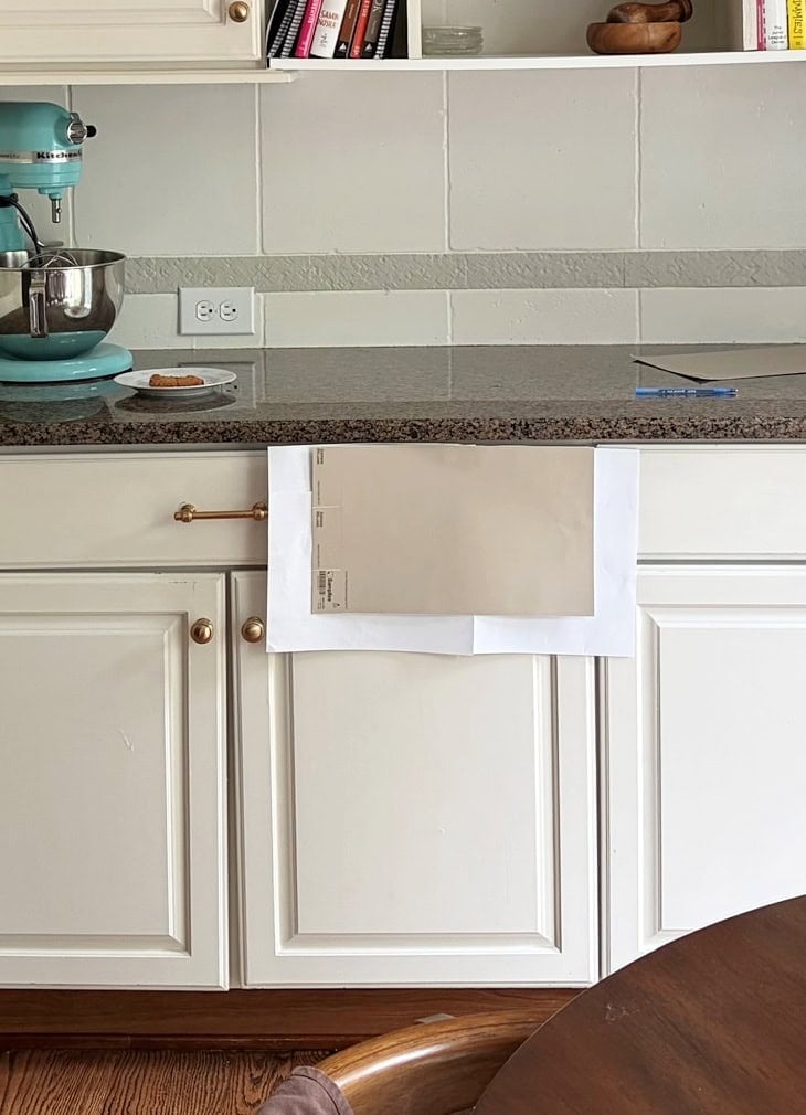 Sherwin Williams beige sample with speckled brown granite for painted cabinets. ORiginal cabinet color is off-white.