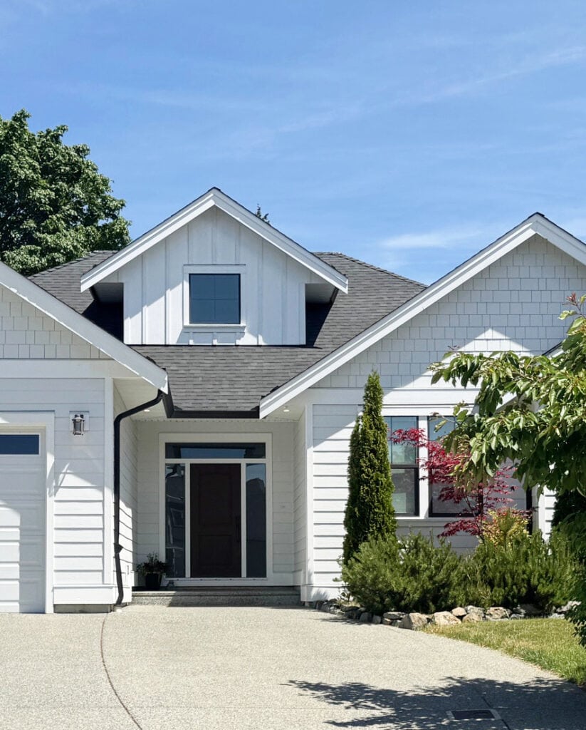 James Hardie Arctic White board and batten, horizontal siding, black windows, white fascia and trim. South-facing exposure