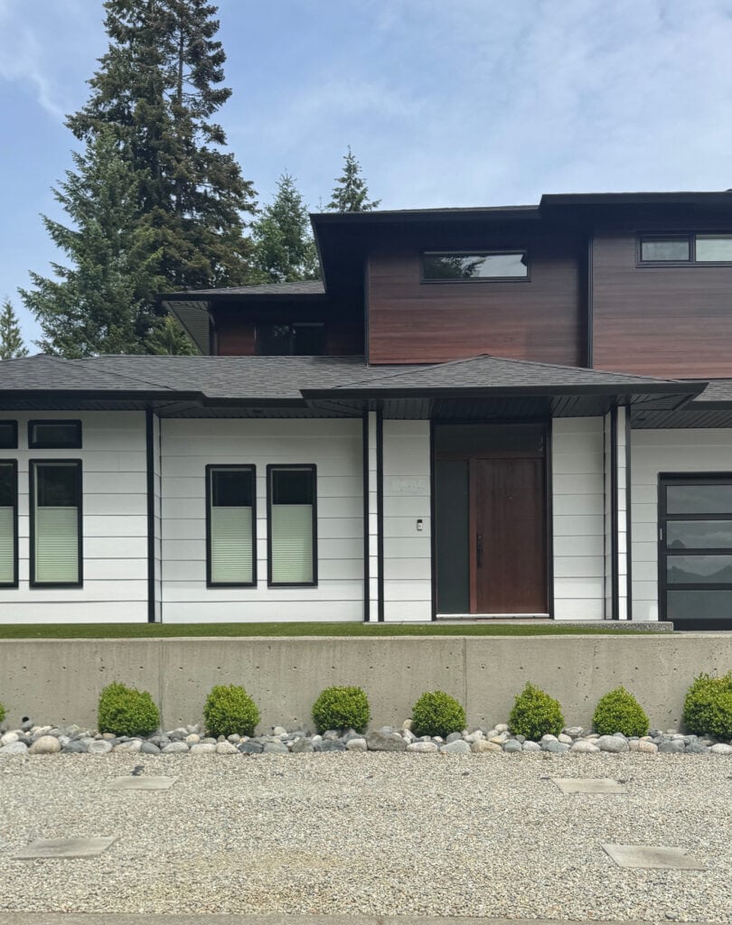 James Hardie Arctic White exterior siding in south-facing exposure with red wood stained, modern or contemporary design with black windows