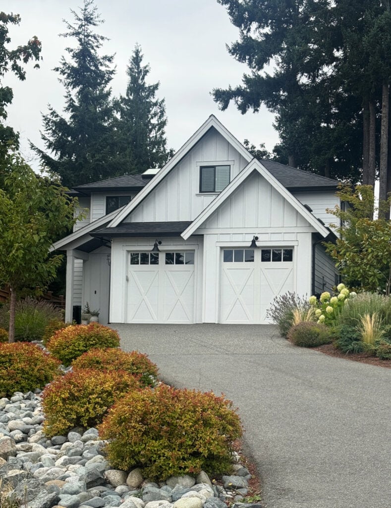 James Hardie Arctic White exterior siding, modern farmhouse style with black windows, garage doors in white, black gutters, white fascia