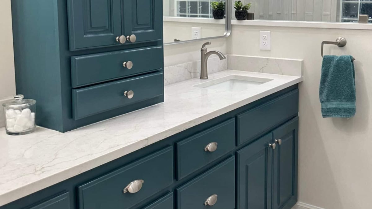 Sherwin-Williams-Riverway-painted-oak-wood-bathroom-vanity-cabetin-marble-look-tile-floor-off-white-quartz-countertop-polished-nickel-hardware-scaled (1)
