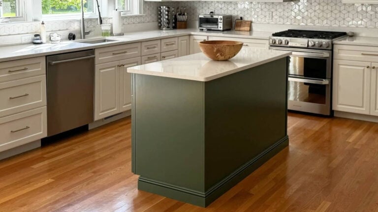 Kitchen island painted Benjamin Moore Peale Green with golden oak flooring and quartz countertop