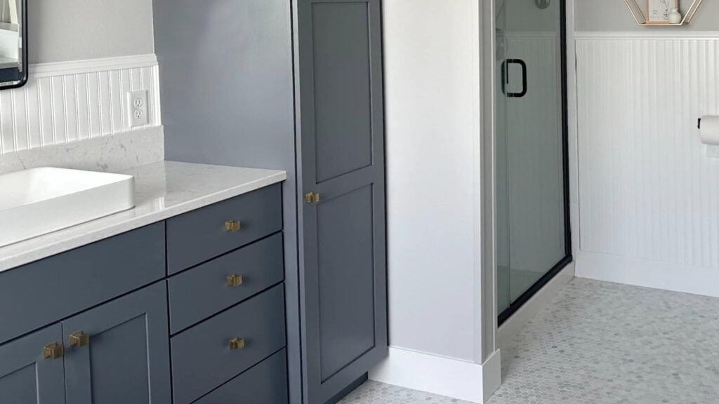 Benjamin Moore Charcoal Slate gray-blue painted bathroom vanitiy with marble hexagon tile floor, Chantilly Lace wainscoting and trim