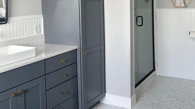 Benjamin Moore Charcoal Slate gray-blue painted bathroom vanitiy with marble hexagon tile floor, Chantilly Lace wainscoting and trim