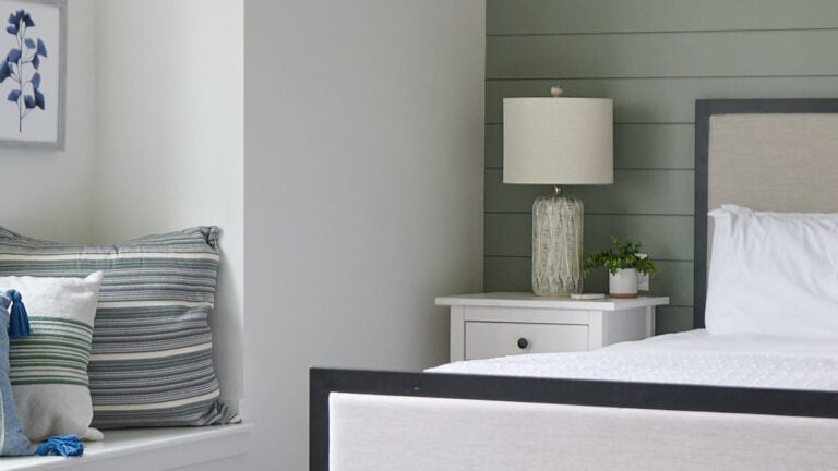 Sherwin Williams Evergreen Fog shiplap accent wall in bedroom with blue accents and Benjamin Moore White Dove