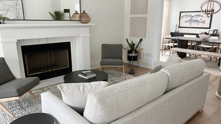 Sherwin Williams Greek Villa lightened on walls in small iving room with fireplace and home decor. Extra White etrim