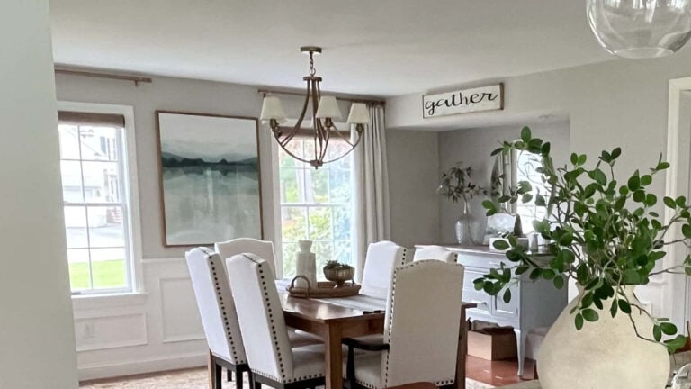 Sherwin Williams Worldly Gray with Benjamin Moore White Dove wainscoting in dining room with gold fixtures
